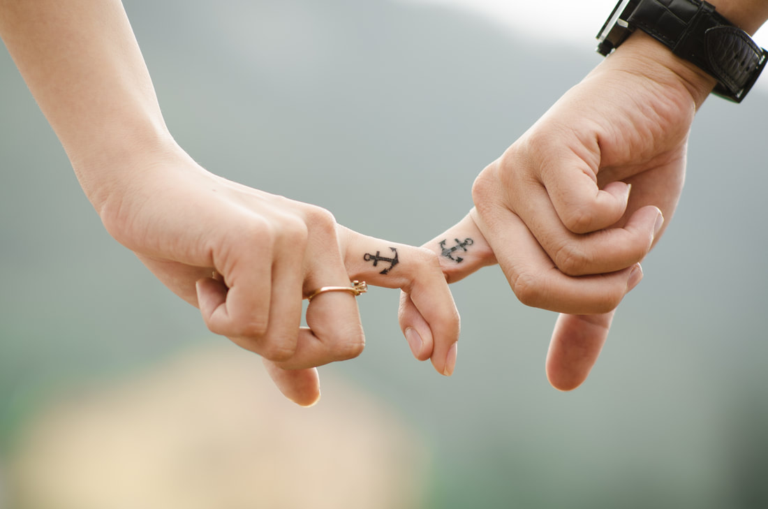holding hands with tattoo